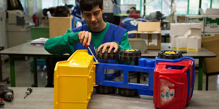 Plastic toy being dismantled in a social workplace.